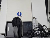 Photo showing Jolike MP3 player, black silicone case with velcro strap, wired headphones, and USB cable beside the original box.