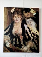 Framed print of Renoir's "La Loge," showing a woman and a man in an impressionist style, ready to hang.