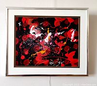 Front view of framed painting hanging on wall showing artwork and silver metal frame with mat