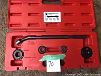 Photo of open red blow molded case showing interior with designated slots for each tool and several tools in place including driver cups, retainer ring, and driver bar.