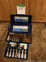 Overview of both socket sets in their cases placed on the floor.