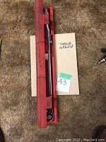 Chrome Snap-on torque wrench in red plastic case, viewed from above