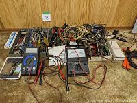 Overall view of all items including multimeters and tray with electronic components and tools