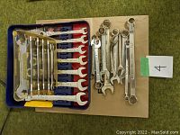 Overview of wrench set in plastic holder and loose wrenches on the side