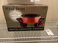 Box of West Bend 4-quart electric fondue pot showing product image and basic details. Box indicates inclusion of 8 forks.