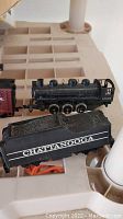 Photo showing black locomotive with tender marked Chattanooga on plastic tray.