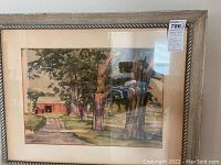 Framed watercolor painting showing landscape with trees, road and barn, signed by artist.