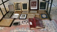 Photo showing all picture frames arranged on the floor in rows, displaying varied sizes and designs.