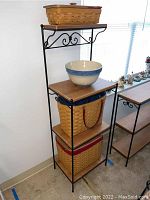 Full view of baker's rack with baskets and ceramic bowl