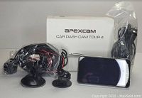 Apexcam Car Dash Cam Tour 4 box along with three dash cams, suction mounts, and cables displayed on a flat surface