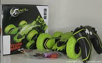 Fancy Stunt Atom Max RC 3 King RC car with its box, remote controller, and accessories displayed on a table.