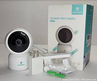 Heimvision HM203 HD Smart WiFi Camera with power adapter, wall mount accessories, instruction manual, and product box.