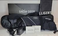 Photo showing black Snow Deer XL heated mittens with two battery packs, charger, storage pouch, and original box