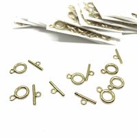 Photo of multiple gold plated brass toggle clasps showing both circular ring and bar components with attached loops, displayed loose and also packaged in multiple sets.