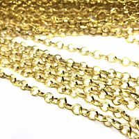 Close-up photo showing multiple strands of shiny 24k gold plated pear link chains laid out together on a white surface.