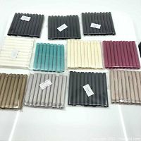 Photo showing all 11 packs of synthetic silk tassels in various colors, arranged neatly on a white surface.