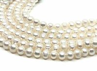 Close-up view of pearl strands showing surface luster and size detail.