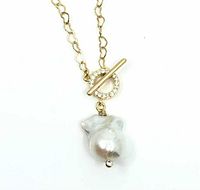 Front view of gold plated heart shaped link chain with toggle clasp and large white baroque pearl pendant with small crystal.
