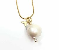 Close-up of the large baroque pearl pendant with a small mermaid tail charm and clear stone accent on 18K gold plated snake chain against white background.