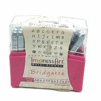 Front view of pink plastic case with clear lid showing metal hand stamps inside and label with alphabet and symbols sample