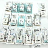 Photo showing all 16 metal hand stamps in their packaging, neatly arranged flat. Labels reveal design names and sizes.