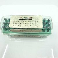 Top view of closed clear plastic case showing label with lowercase alphabet and bonus symbols