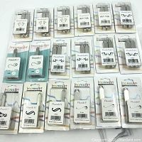 Full set of 18 packaged metal hand stamps by ImpressArt with swirl and flourish designs for soft metals, arranged in rows and sealed on packaging cards.