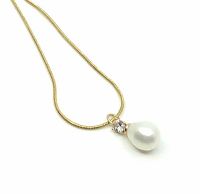 Close-up photo of white drop pearl pendant with CZ solitaire on thin gold chain.