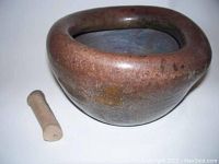 Side and angled view of brown ceramic mortar with pestle