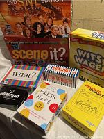 Photo of 8 board and card games including Scene It?, Wits & Wagers Deluxe, What?, Contender, Press Here, Relative Insanity, Superfight, and The Contender.