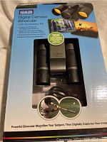 Box front showing product name and compact binoculars with yellow tinted lenses in packaging window