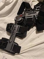 Gray Donjoy knee leg brace showing frame and straps laid flat on white surface