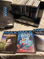 Close-up of three IMAX DVD cover titles Mountain Gorilla, Into the Deep, Blue Planet with the full 19 DVD collection lined up in background