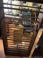 Top down view of large CD rack showing construction with wooden rods and dark finish oak sides.