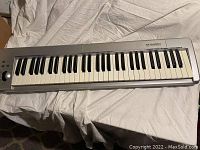 Full view of M-Audio Keystation 61ES MIDI controller keyboard showing 61 keys and control panel.