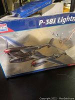 Photo of sealed Monogram P-38J Lightning 1:48 scale model airplane kit box showing artwork and sealed condition