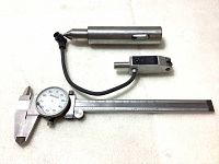 Mitutoyo dial caliper alongside a bidirectional touch trigger probe with cable, displayed on a white background.