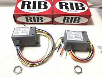 Two new RIB enclosed relay boxes with wires and mounting nuts displayed horizontally alongside two original red and white RIB branded boxes.