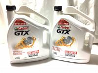 Front side of two white 5-litre containers of Castrol GTX SAE 20W-50 motor oil with branding and product details.
