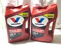 Two new 5L red containers of Valvoline High Mileage MaxLife SAE 5W-30 motor oil side by side.