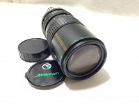 Front view of Auto Makinon MC Zoom 80-200mm f4.5 lens with front lens cap and rear lens cap beside it.