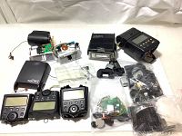 Lot showing multiple Canon Speedlite 550EX camera flash units, housings, various flash components including bulbs and electronic parts arranged on a white background.