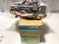 The vertical measuring attachment sealed in plastic placed on the original cardboard box with label.