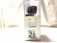 Full front view of Safari E 4K WiFi action camera in clear protective casing atop box showing branding and 4K resolution feature.