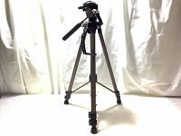 Front view of Optex OPT155 tripod standing with legs extended and pan handle visible.