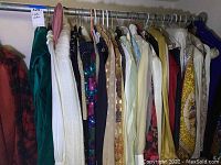 Wide view of assorted women's clothing on hangers showing various items in different colors and textures.