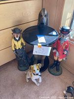 Full lot overview showing large dog table with tray, two fox statues, and small dog figurine at front