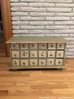 Front elevation showing entire cabinet with 18 small drawers and distressed finish