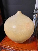 Front view of large beige mid-century modern bulbous vase showing wide rounded body and narrow neck.