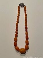 Full view of necklace laid flat showing bead arrangement and length